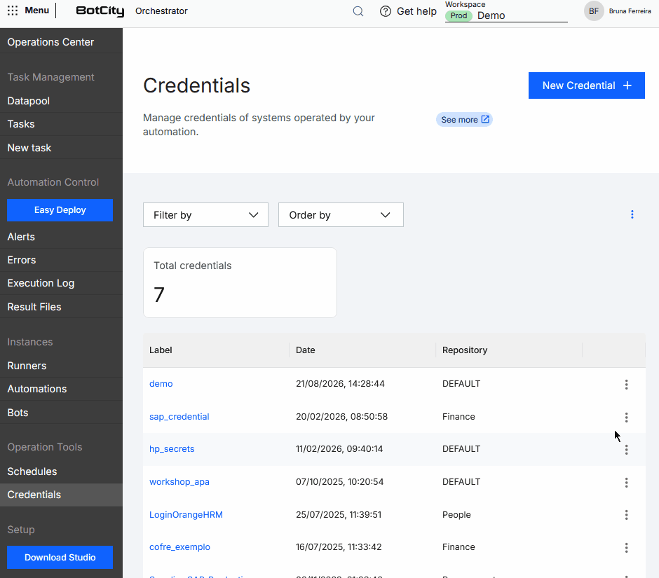 Move Credential to another repository GIF of the BotCity Orchestrator, showing the Credentials menu. The user opens the actions menu of a credential in the list and selects the option to move the credential to another repository.